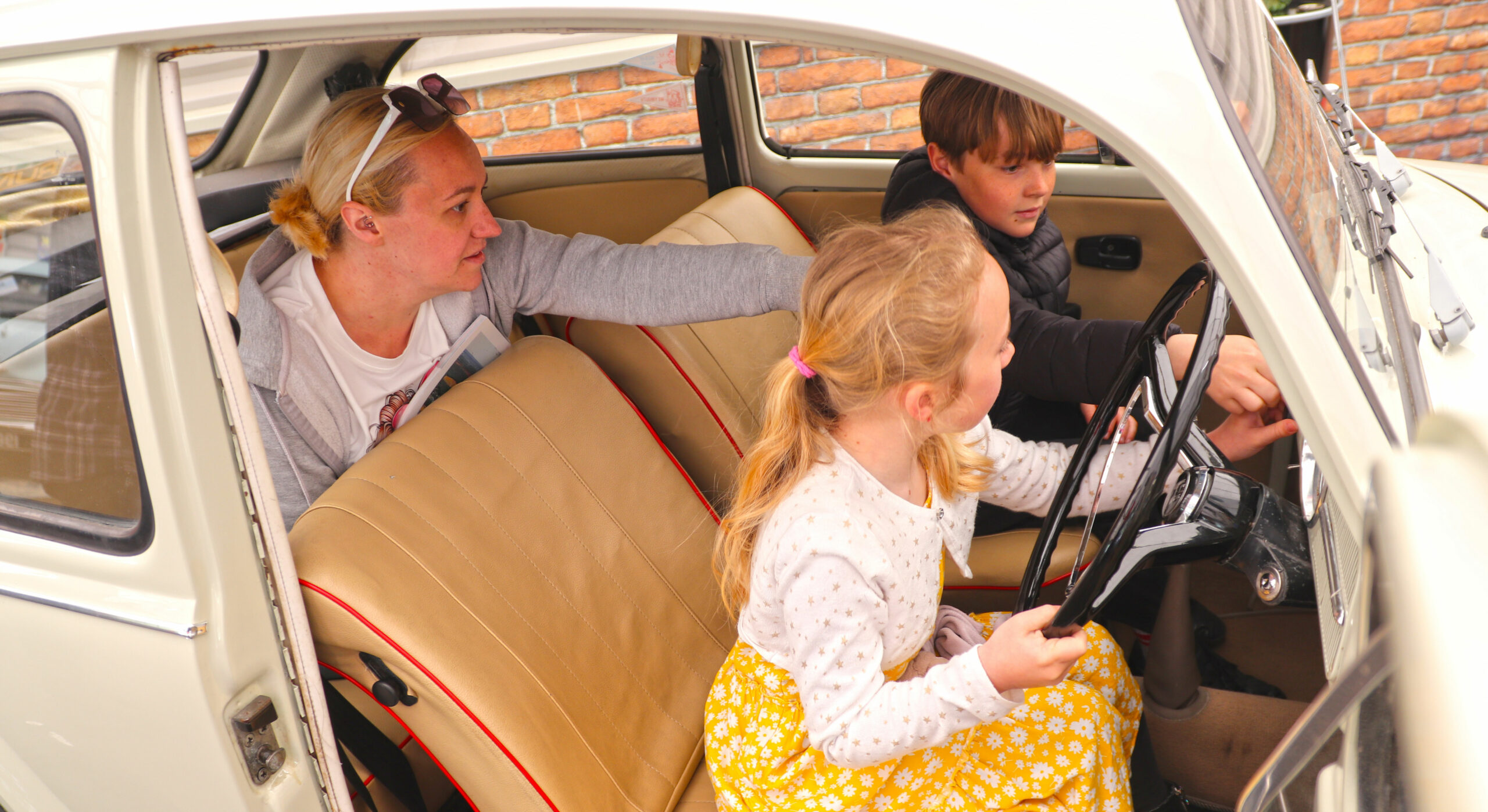 Visitors inside the cars of new attraction We Had One of Those at Beaulieu